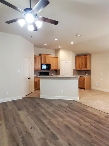 a view of kitchen with microwave and cabinets