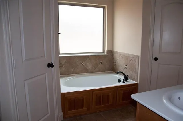 a bathroom with a tub and a sink