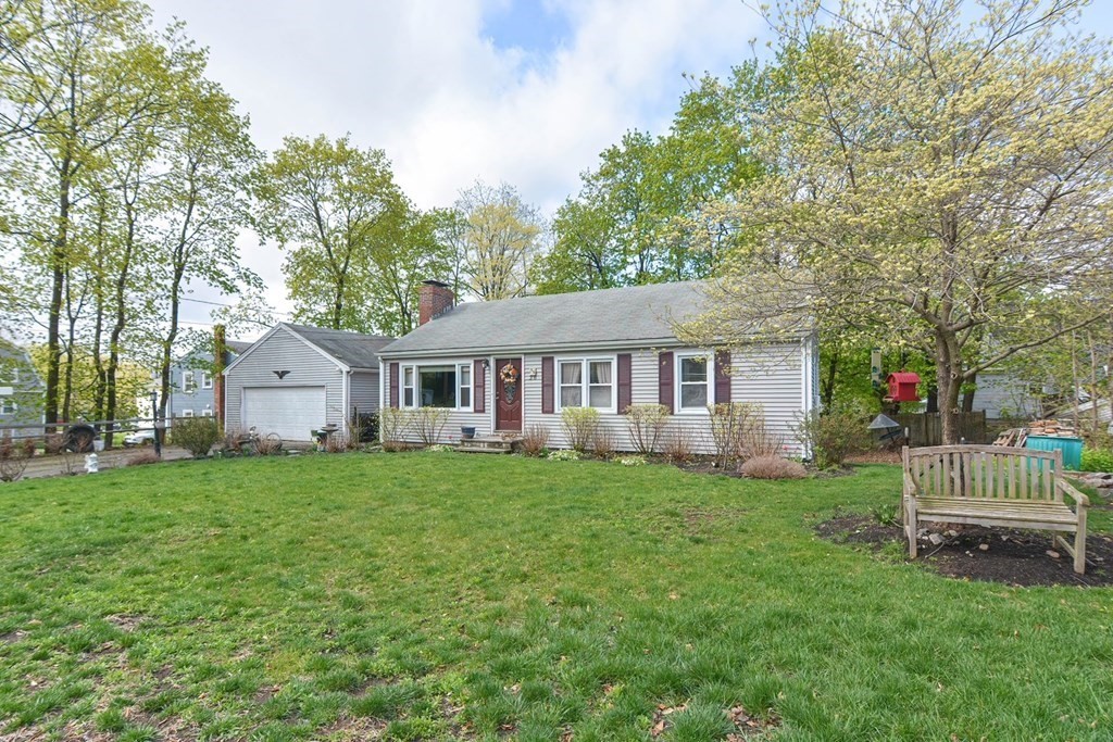 38 Spring Street Plainville, MA 02762 - Photo 2 of 23 a front view of a house with a garden and trees