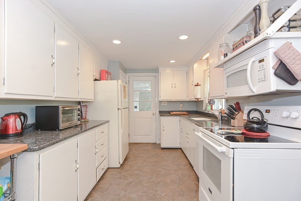 38 Spring Street Plainville, MA 02762 - Photo 6 of 23 a kitchen with stainless steel appliances granite countertop a sink and cabinets