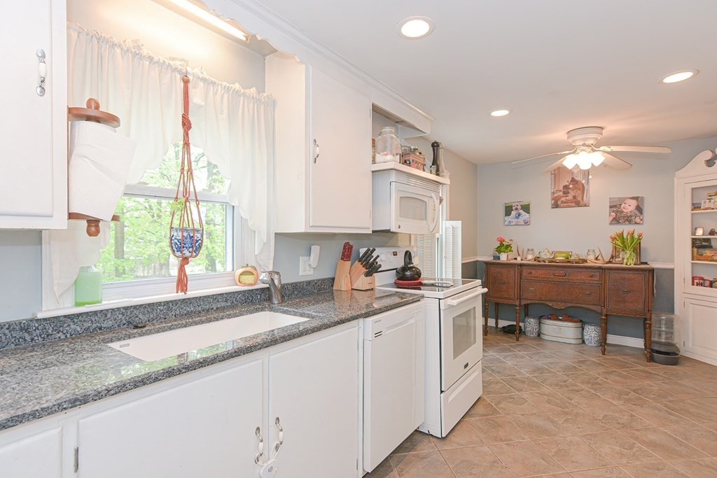 38 Spring Street Plainville, MA 02762 - Photo 7 of 23 a kitchen with a sink stove and cabinets