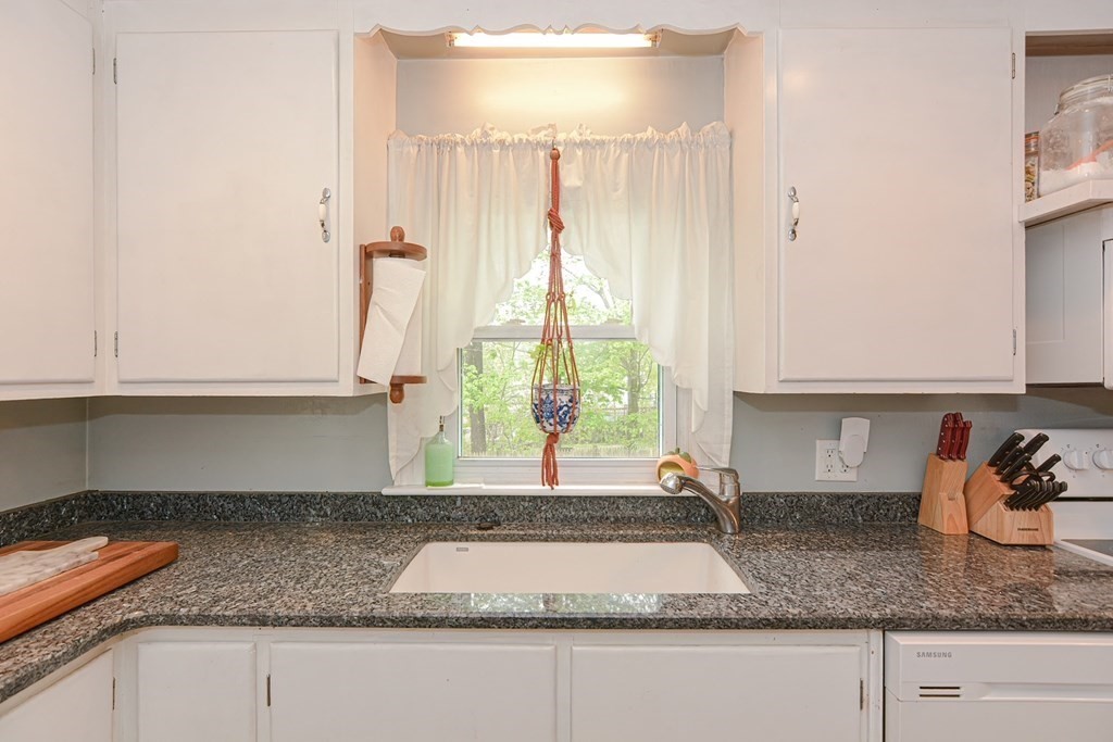 38 Spring Street Plainville, MA 02762 - Photo 10 of 23 a kitchen with granite countertop a window and a sink