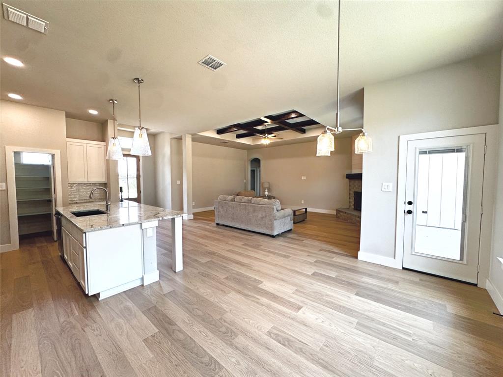 1005 Ronnie Court Springtown, TX 76082 - Photo 12 of 27 Open concept living space featuring light wood-finish flooring