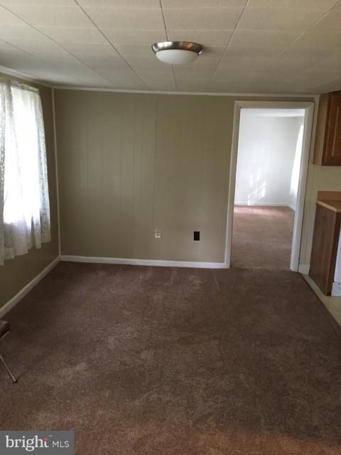 20033 Point Lookout Road Lexington Park, MD 20653 - Photo 6 of 12 an empty room with windows and entrance
