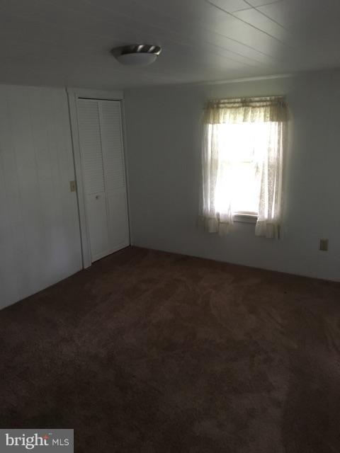 20033 Point Lookout Road Lexington Park, MD 20653 - Photo 7 of 12 an empty room with a empty space and windows