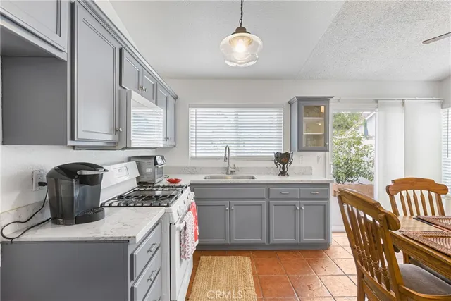 a kitchen that has a sink and a stove in it