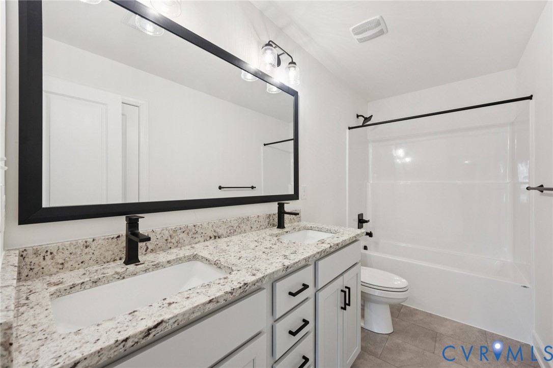 13619 Brandy Oaks Road Chesterfield, VA 23832 - Photo 14 of 28 a bathroom with a granite countertop sink toilet and shower