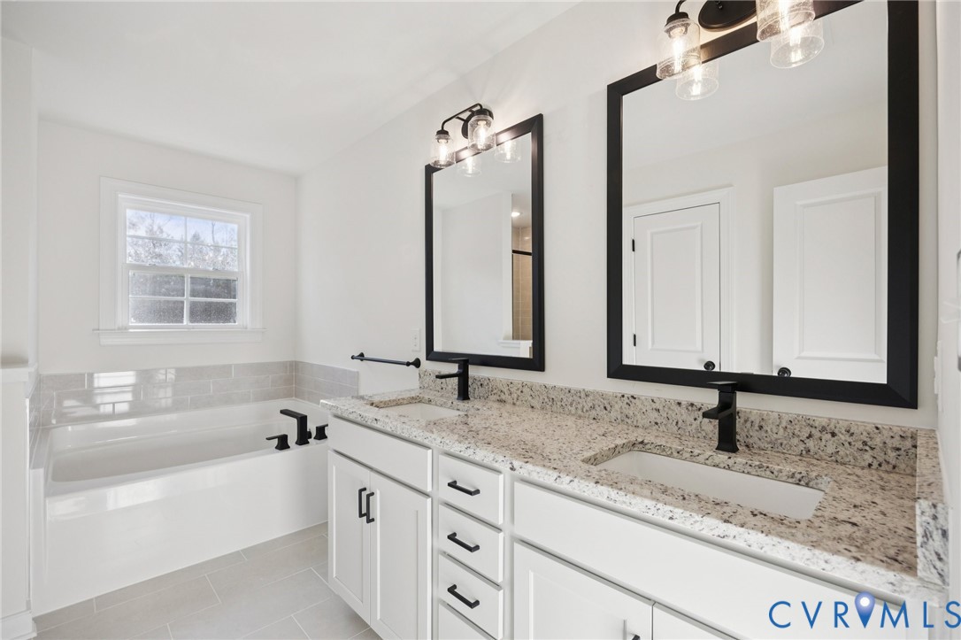 13619 Brandy Oaks Road Chesterfield, VA 23832 - Photo 21 of 28 a bathroom with a granite countertop sink and a bathtub