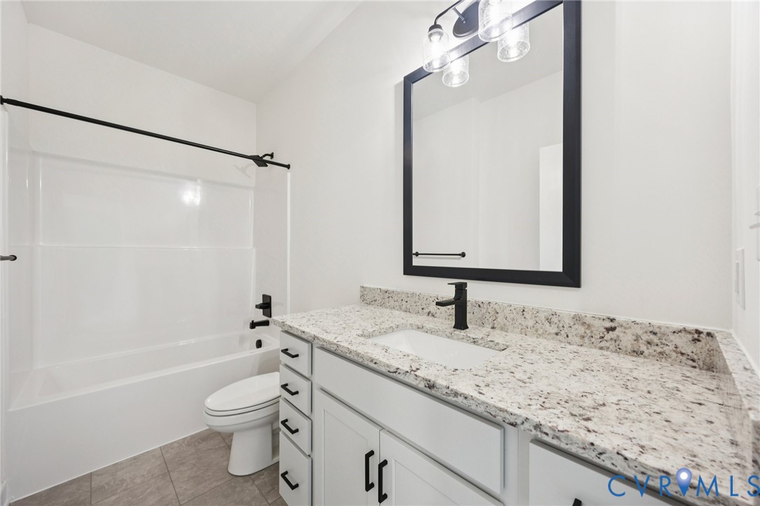 13619 Brandy Oaks Road Chesterfield, VA 23832 - Photo 7 of 28 a bathroom with a granite countertop sink a toilet and a mirror