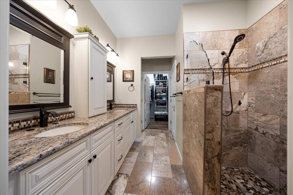 9586 Southwest 70th Loop Ocala, FL 34481 - Photo 14 of 21 a bathroom with a granite countertop sink mirror and shower