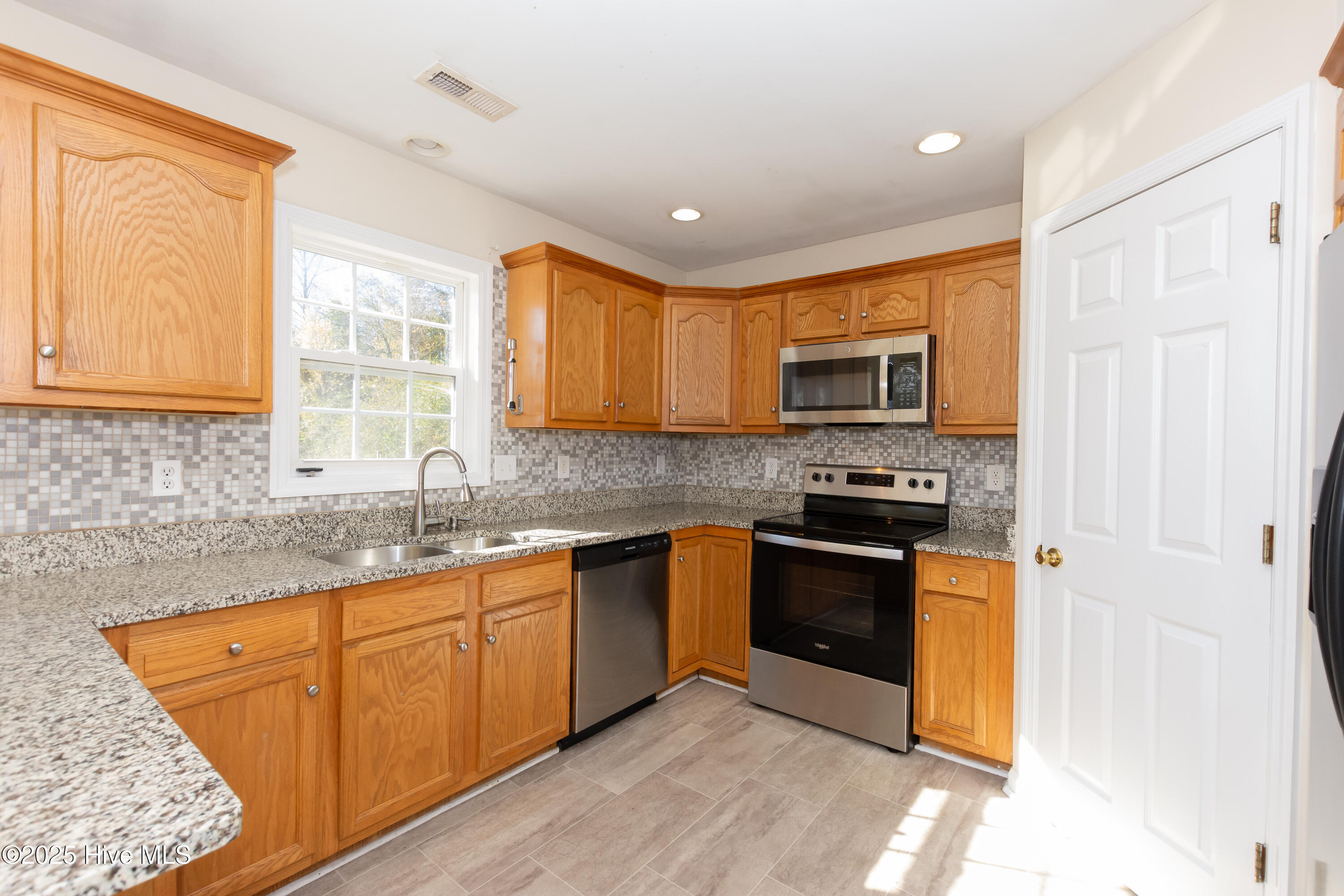 236 Petersburg Road Richlands, NC 28574 - Photo 5 of 39 Kitchen with granite counter tops, stainless appliances and a pantry