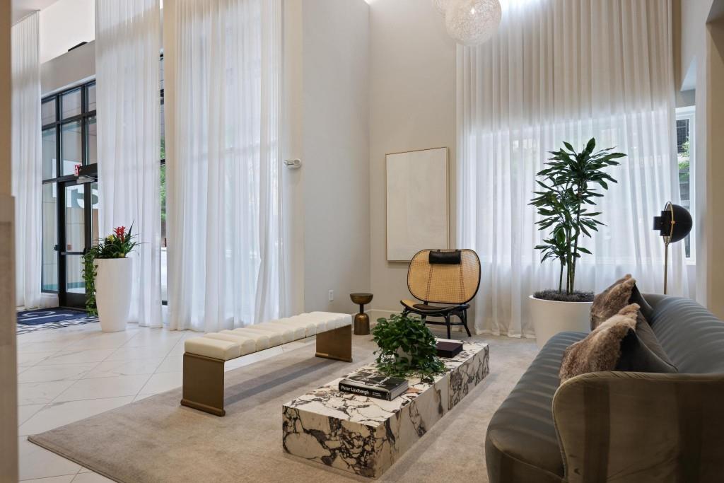 775 Juniper Street Northeast, Unit 602 Atlanta, GA 30308 - Photo 6 of 40 a living room with furniture and a potted plant