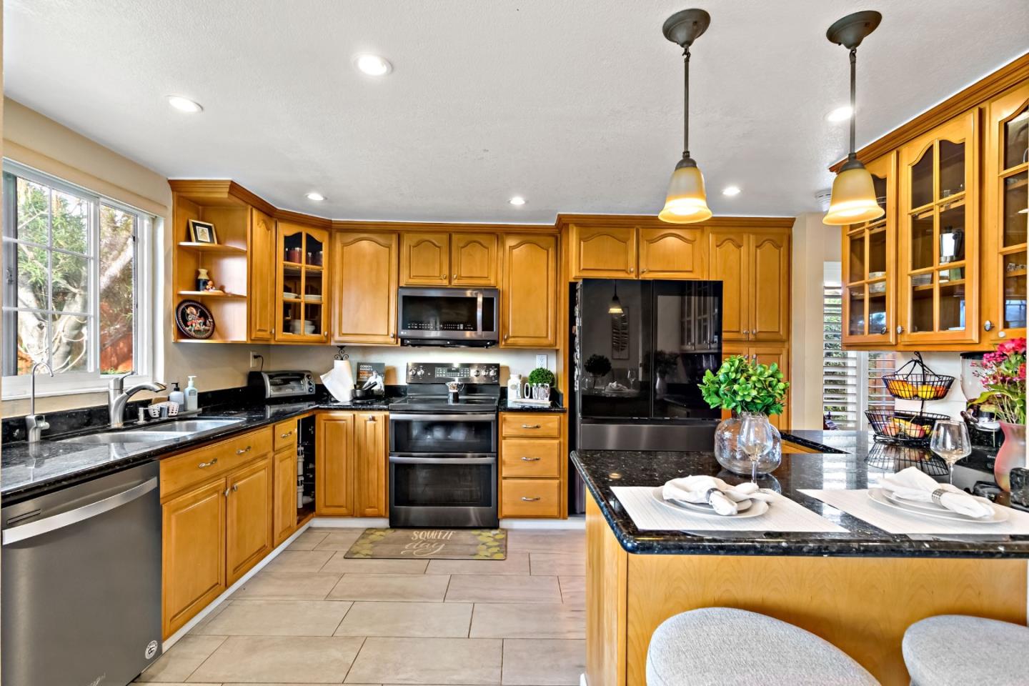 2831 Riedel Road San Jose, CA 95135 - Photo 5 of 53 a kitchen with stainless steel appliances granite countertop wooden cabinets a sink a stove and a refrigerator