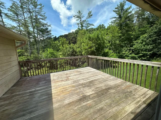 a balcony with wooden floor and fence