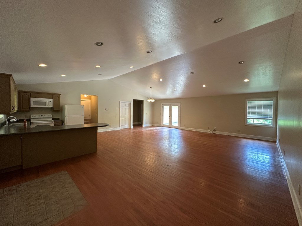 655 Sunset Drive Young Harris, GA 30582 - Photo 3 of 16 an empty room with wooden floor and windows