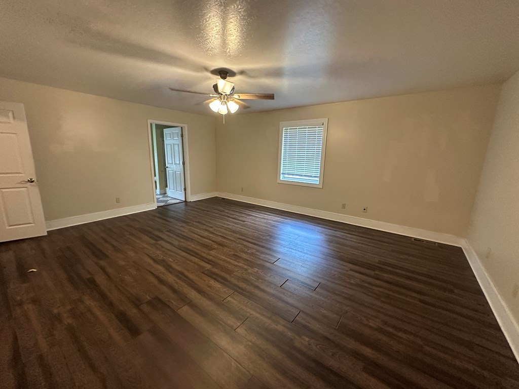 655 Sunset Drive Young Harris, GA 30582 - Photo 7 of 16 a view of empty room with wooden floor and fan
