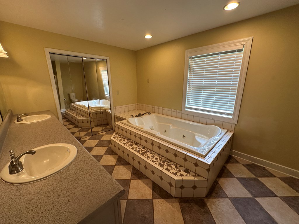 655 Sunset Drive Young Harris, GA 30582 - Photo 8 of 16 a bathroom with a sink a mirror and a bathtub