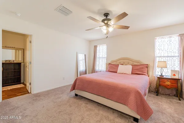 a bedroom with a large bed and a chandelier
