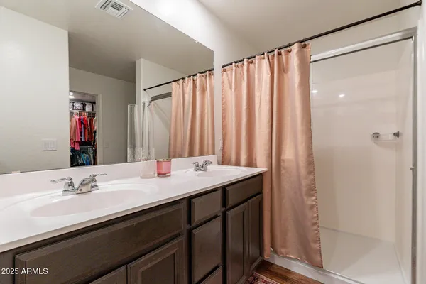 a bathroom with a double vanity sink and a mirror