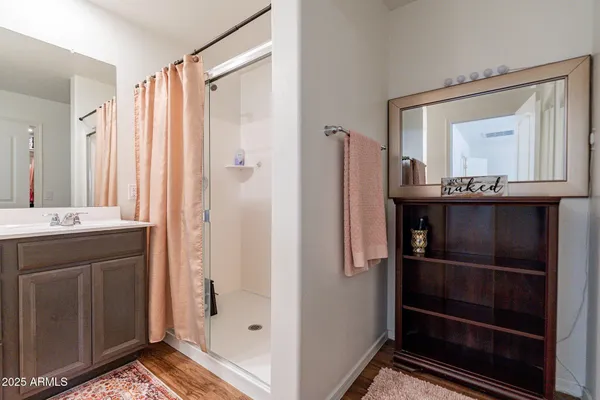 a bathroom with a shower sink and mirror