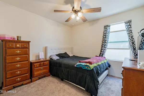 a bedroom with a bed and a chandelier