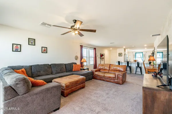 a living room with furniture ceiling fan and a rug