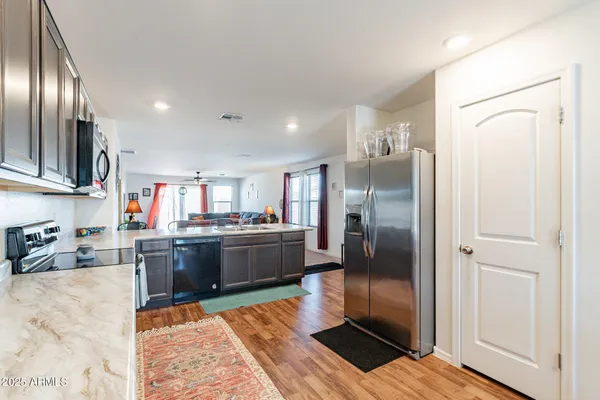 a kitchen with stainless steel appliances granite countertop a refrigerator and a sink