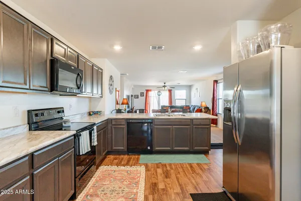 a kitchen with stainless steel appliances granite countertop a sink dishwasher stove and refrigerator