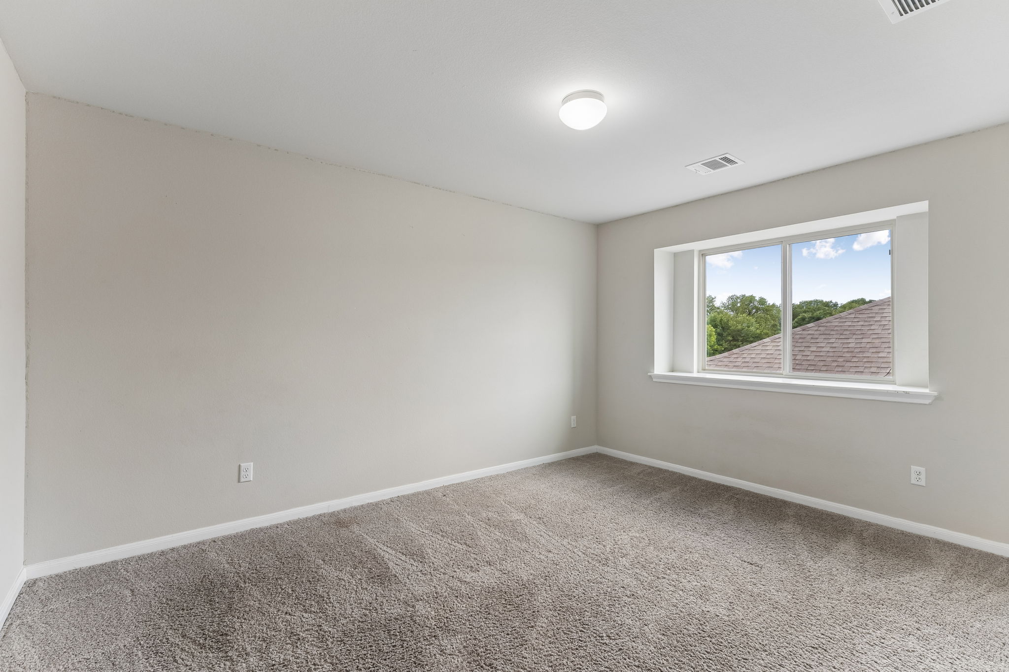 301 Rimrock Court Bastrop, TX 78602 - Photo 18 of 21 A well-lit secondary room offers ample space with plush carpeting and natural light.