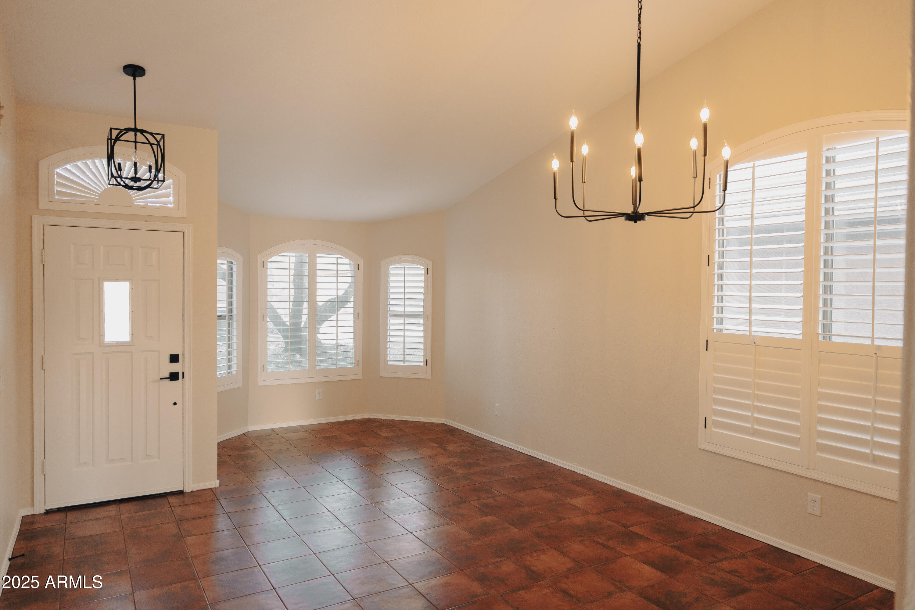 4705 East Jaeger Road Phoenix, AZ 85050 - Photo 2 of 44 a view of empty room with wooden floor and fan