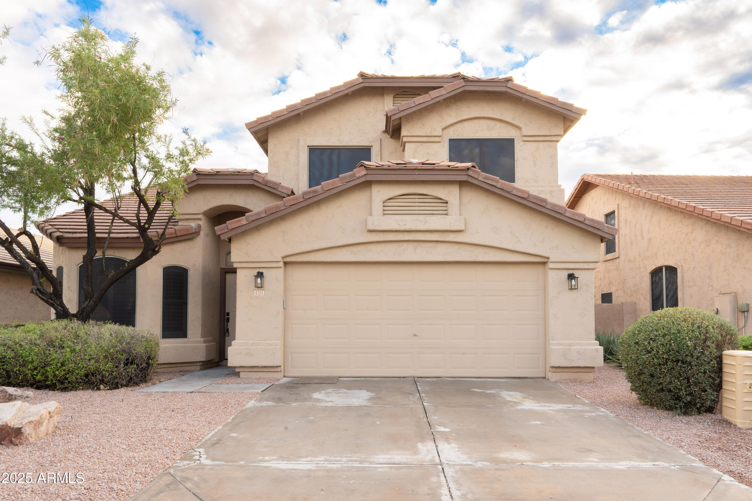 4705 East Jaeger Road Phoenix, AZ 85050 - Photo 43 of 44 a view of a white house with a small yard and large tree