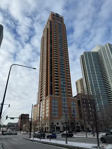 a view of a tall building next to a road