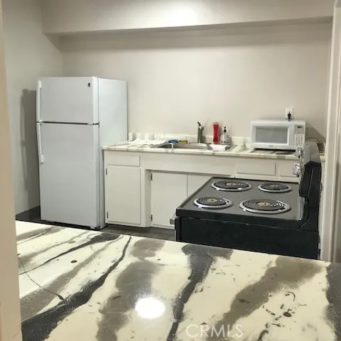 3156 Esplanade, Unit 306 Chico, CA 95973 - Photo 17 of 18 a kitchen with a stove and a refrigerator