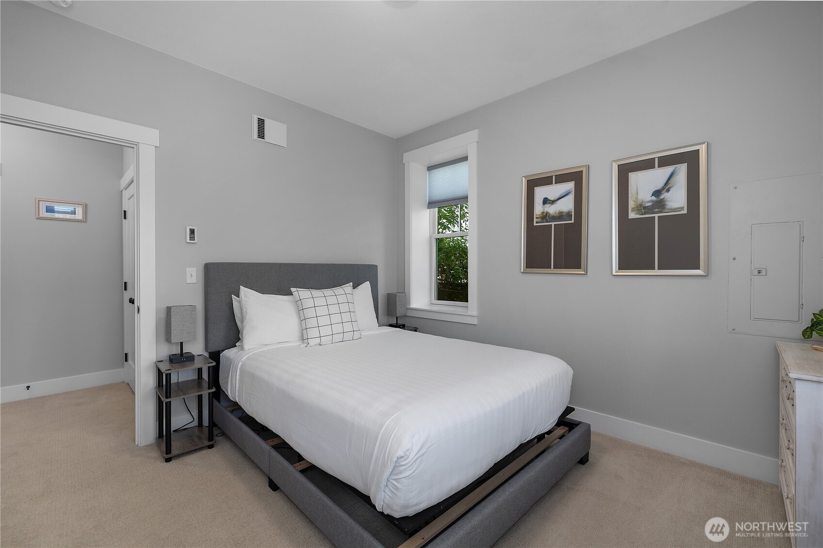 61 Horizon Street Pacific Beach, WA 98571 - Photo 18 of 29 a large bed sitting in a bedroom next to a window and a chandelier