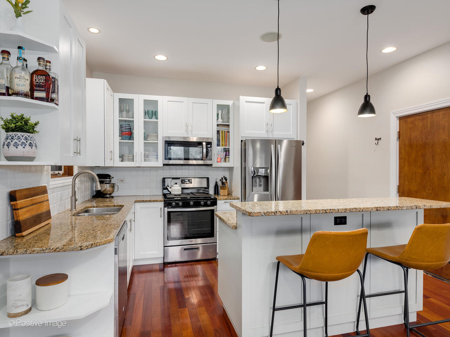 2033 West Crystal Street, Unit 2 Chicago, IL 60622 - Photo 11 of 22 a kitchen with stainless steel appliances granite countertop a refrigerator a sink dishwasher a stove top oven a dining table and chairs with wooden floor