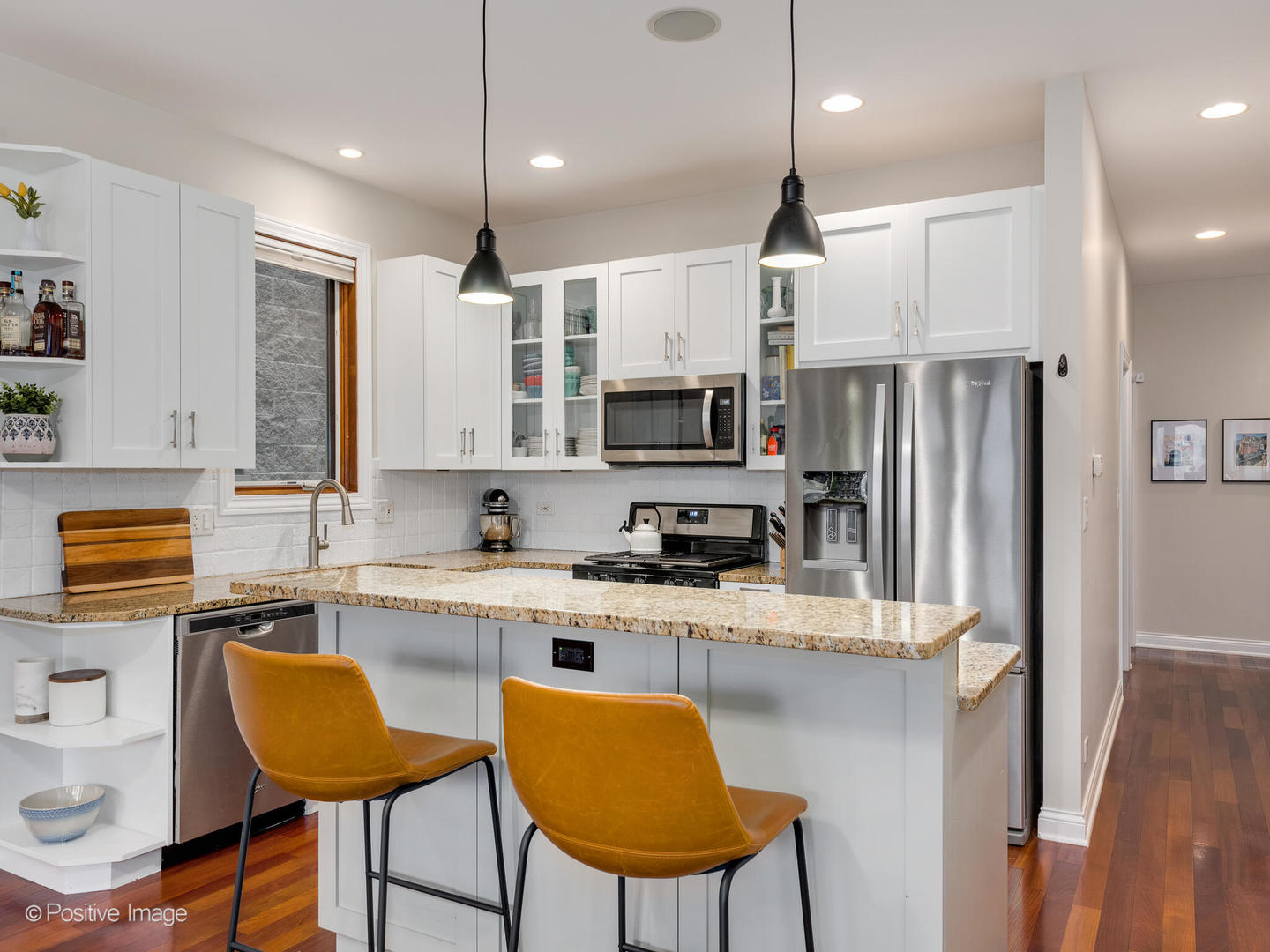2033 West Crystal Street, Unit 2 Chicago, IL 60622 - Photo 12 of 22 a kitchen with stainless steel appliances granite countertop a sink a stove a refrigerator and island with wooden floor