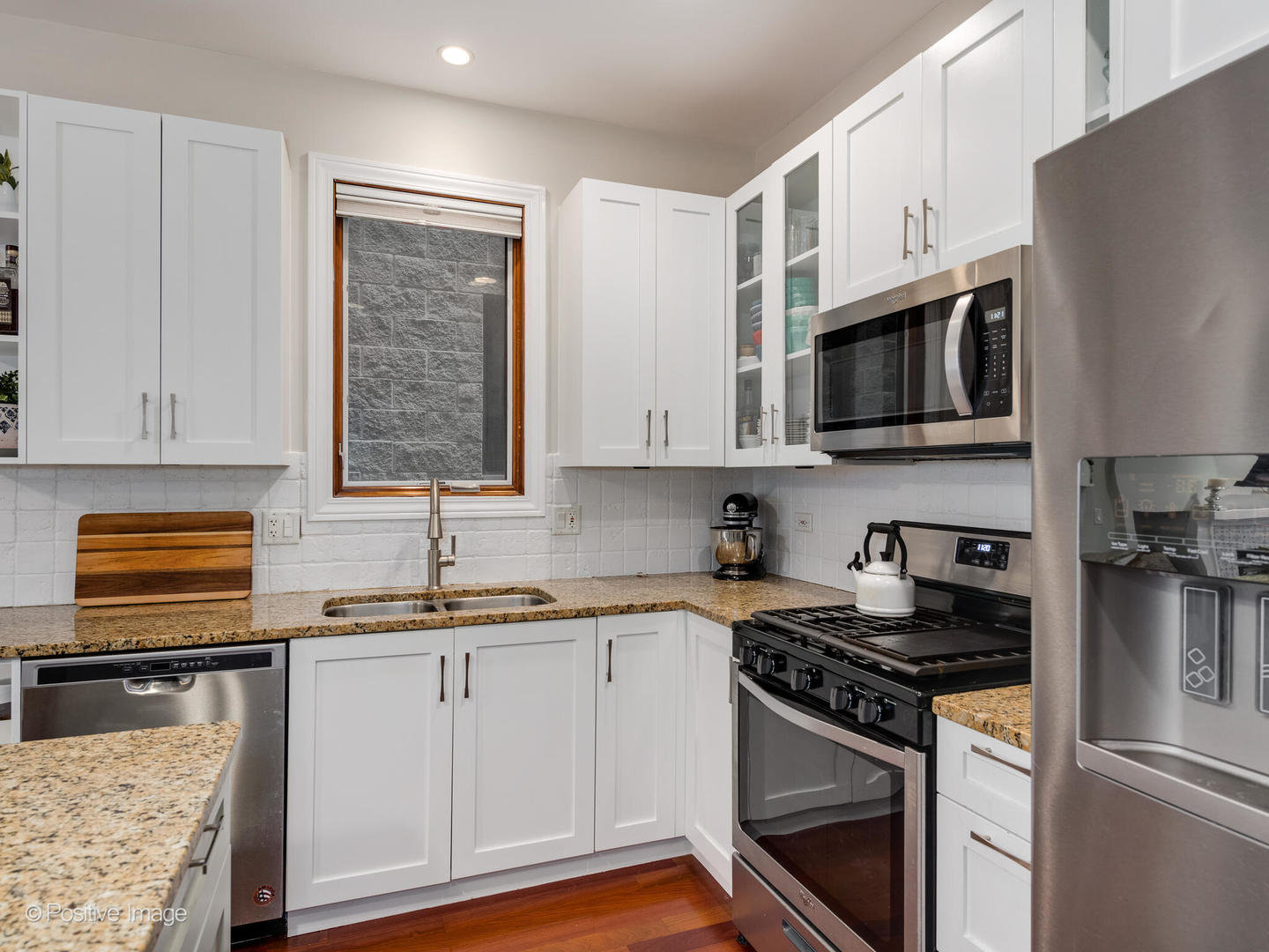 2033 West Crystal Street, Unit 2 Chicago, IL 60622 - Photo 13 of 22 a kitchen with stainless steel appliances granite countertop a stove a sink dishwasher and a microwave oven with cabinets