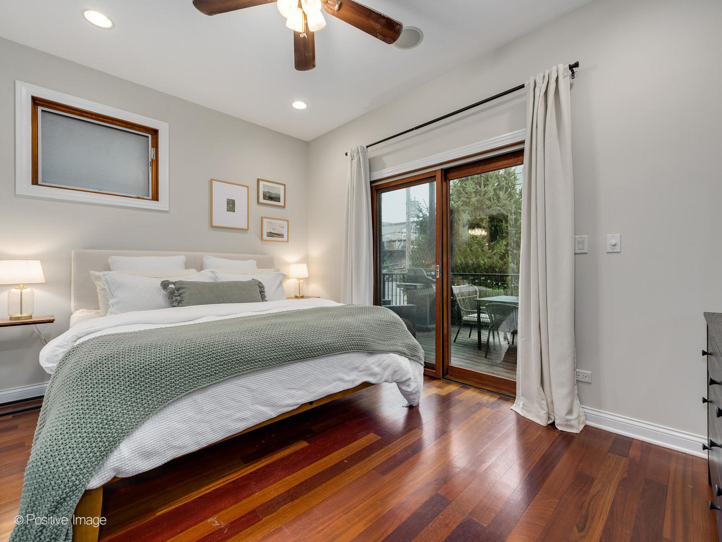 2033 West Crystal Street, Unit 2 Chicago, IL 60622 - Photo 17 of 22 a bedroom with a large bed and a chandelier