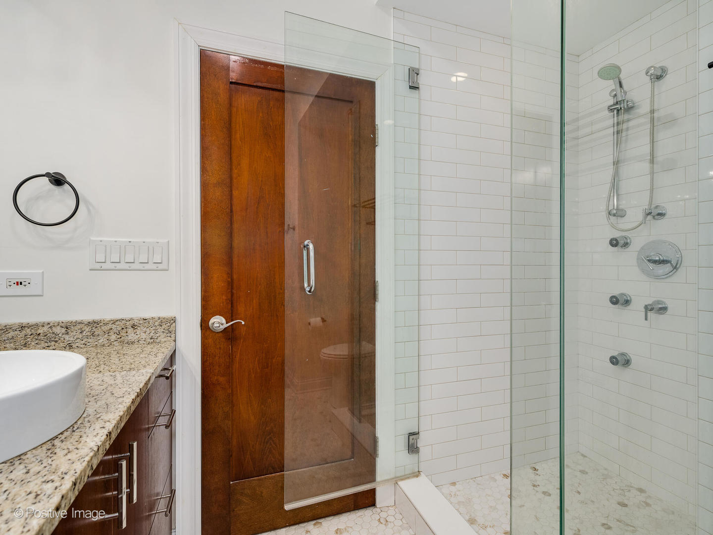 2033 West Crystal Street, Unit 2 Chicago, IL 60622 - Photo 19 of 22 a bathroom with a granite countertop shower mirror and a sink