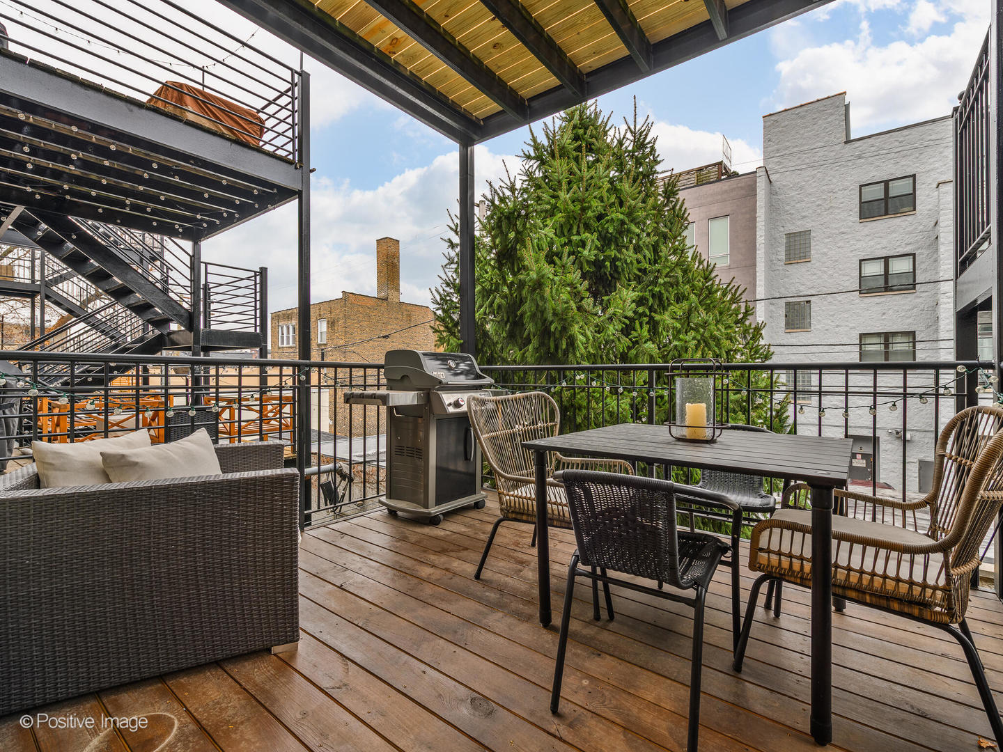 2033 West Crystal Street, Unit 2 Chicago, IL 60622 - Photo 22 of 22 a view of a roof deck with table and chairs a barbeque with wooden floor and fence
