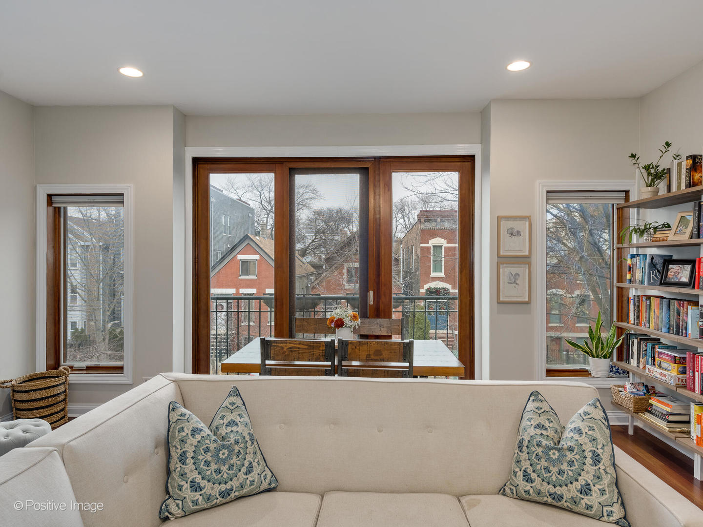 2033 West Crystal Street, Unit 2 Chicago, IL 60622 - Photo 5 of 22 a living room with couch a bookshelf and a large window