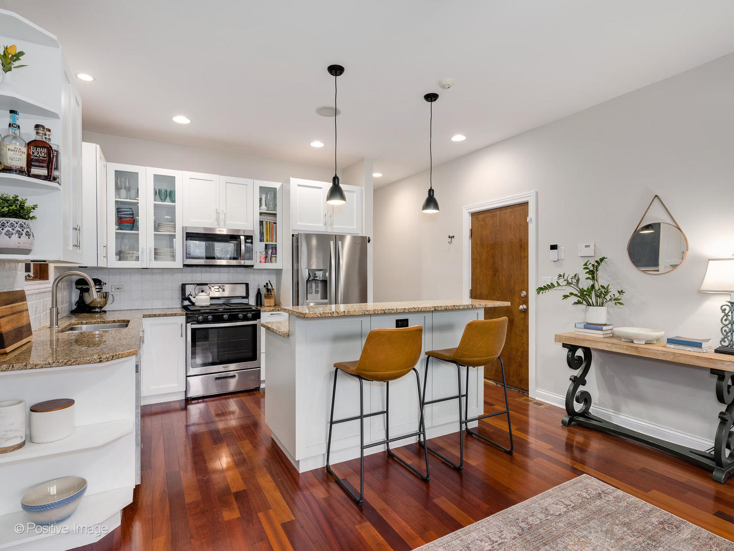 2033 West Crystal Street, Unit 2 Chicago, IL 60622 - Photo 10 of 22 a kitchen with stainless steel appliances kitchen island granite countertop a stove a sink a refrigerator and cabinets