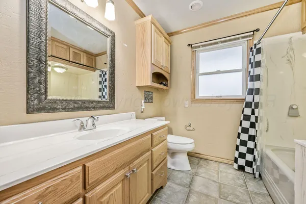 a bathroom with a sink a toilet a shower and a mirror