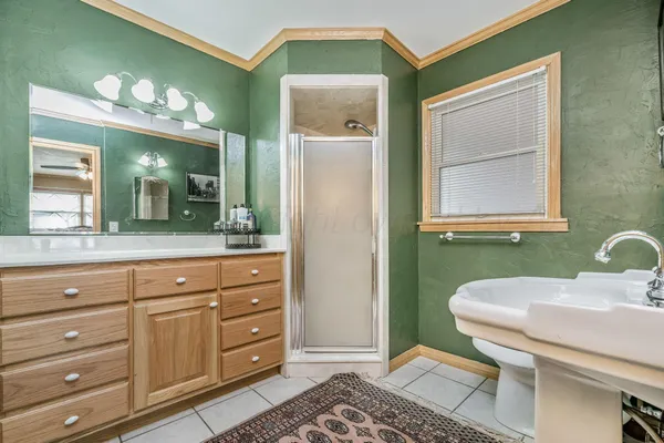 a bathroom with a sink a toilet and mirror