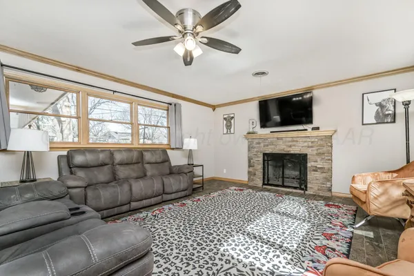a living room with furniture a flat screen tv and a fireplace