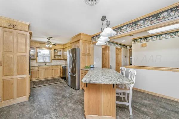 a kitchen with refrigerator and cabinets