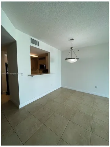 a view of a livingroom with wooden floor and a ceiling fan