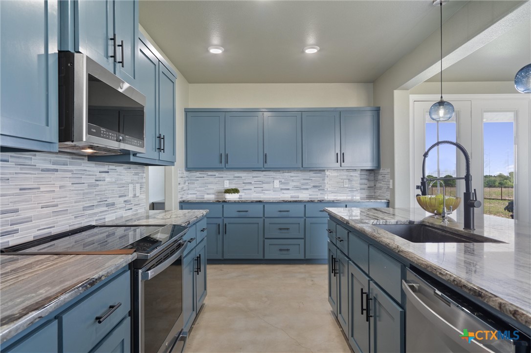 15073 Armstrong Ests Road Salado, TX 76571 - Photo 20 of 44 a kitchen with a sink stove top oven and microwave