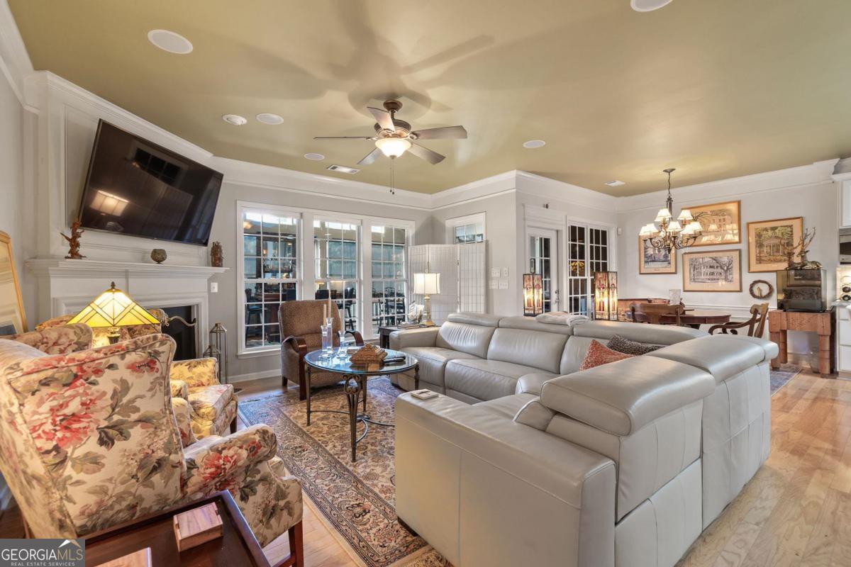 1151 Spring Station Road Greensboro, GA 30642 - Photo 11 of 60 a living room with furniture kitchen view and a flat screen tv