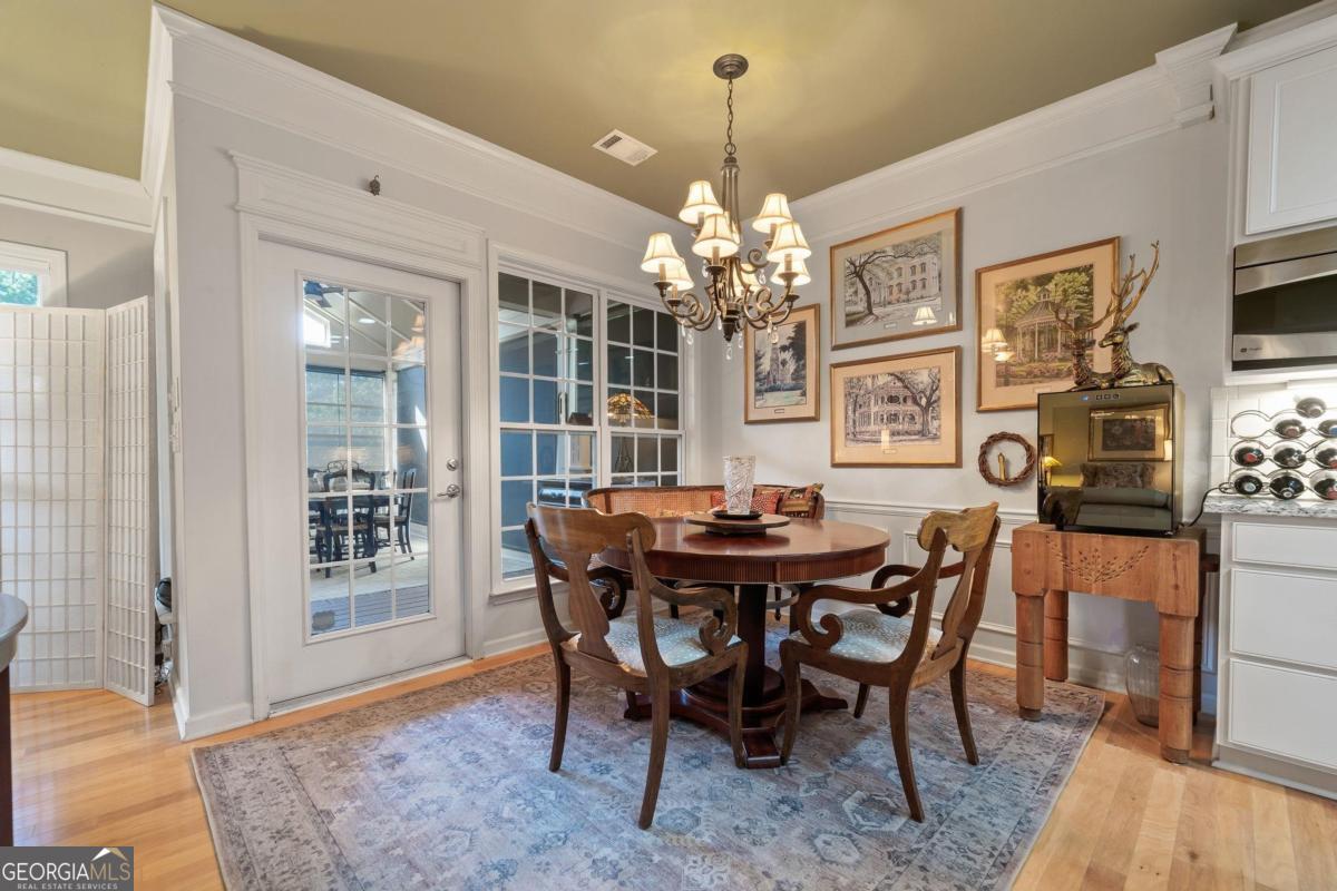1151 Spring Station Road Greensboro, GA 30642 - Photo 14 of 60 a view of a dining room with furniture and chandelier